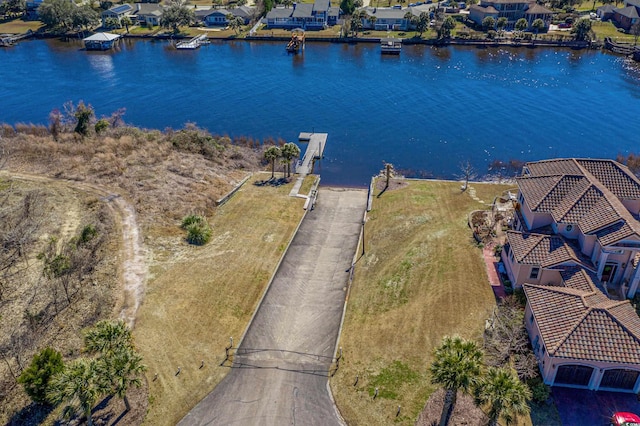 drone / aerial view featuring a residential view and a water view