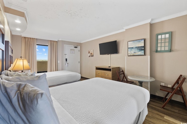 bedroom with dark hardwood / wood-style floors and ornamental molding