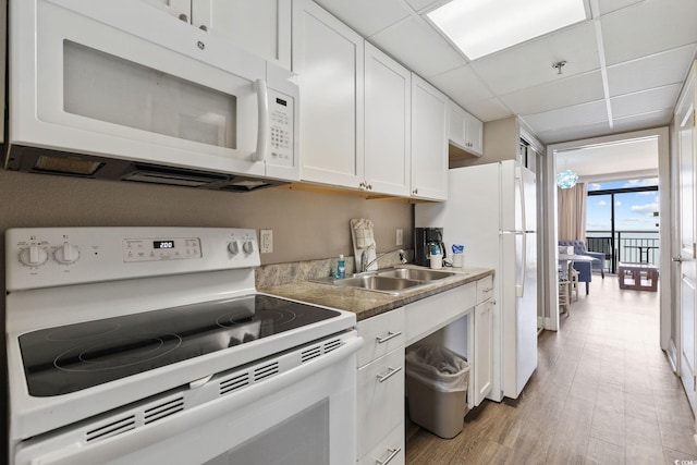 kitchen featuring white cabinets, a paneled ceiling, white appliances, floor to ceiling windows, and light hardwood / wood-style flooring