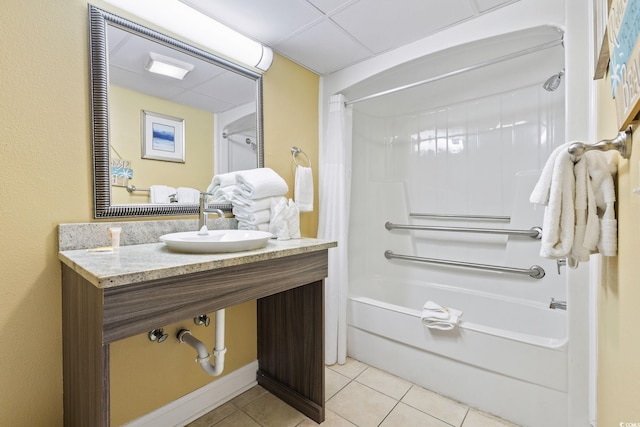 bathroom with tile patterned floors, shower / bathtub combination with curtain, and sink