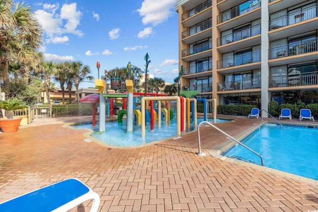 view of pool with a hot tub