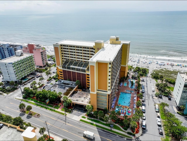 drone / aerial view featuring a water view and a view of the beach