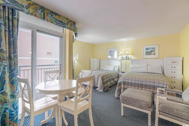 bedroom featuring carpet floors, a textured ceiling, and access to exterior