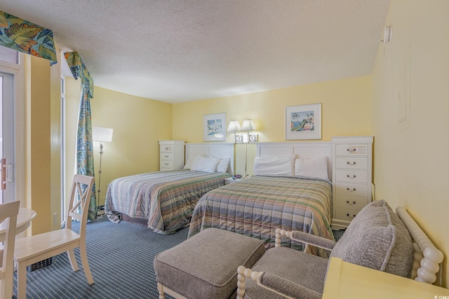 carpeted bedroom with a textured ceiling