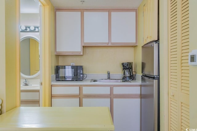 2701 S Ocean Blvd Unit 710, North Myrtle Beach, SC 29582 - kitchen featuring freestanding refrigerator, black microwave, light countertops, and white cabinetry