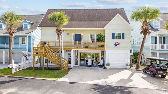 4524 Landing Rd, Little River, SC 29566 - coastal inspired home featuring an attached garage, driveway, and roof with shingles