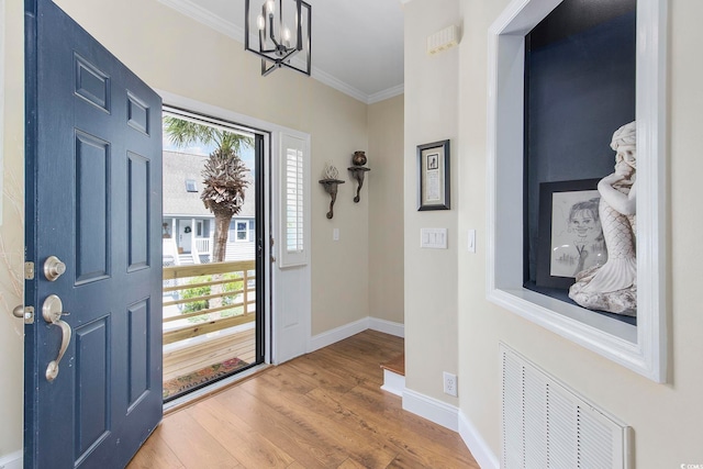 4524 Landing Rd, Little River, SC 29566 - foyer entrance with ornamental molding, wood finished floors, plenty of natural light, and a chandelier