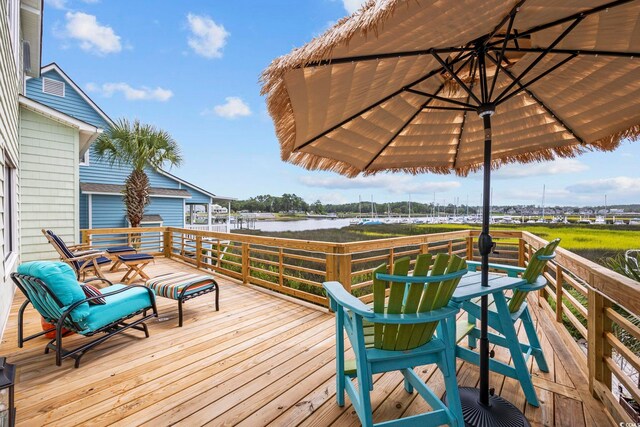 wooden terrace featuring a water view