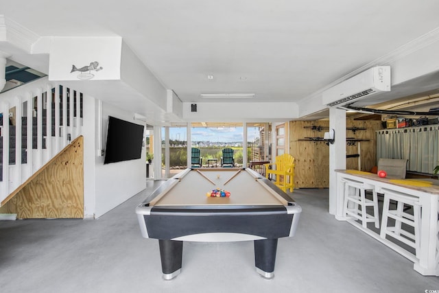 rec room featuring concrete flooring, ornamental molding, a wall unit AC, and billiards