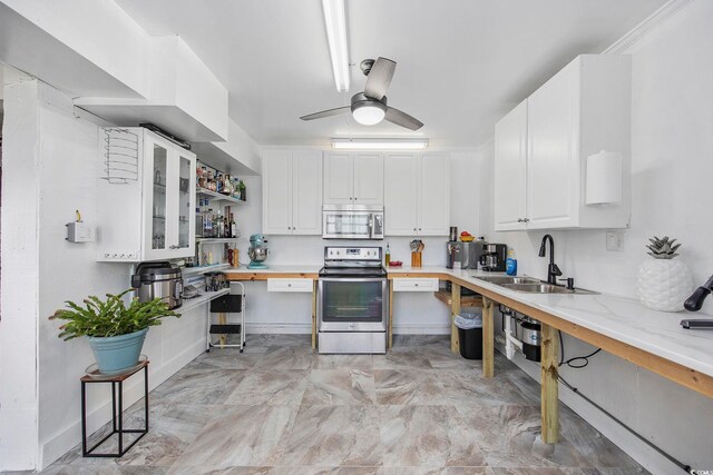 kitchen with sink, ceiling fan, white cabinetry, butcher block counters, and stainless steel appliances