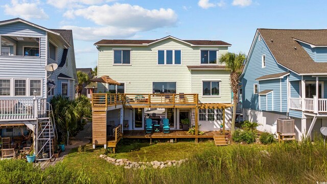 back of property with a wooden deck