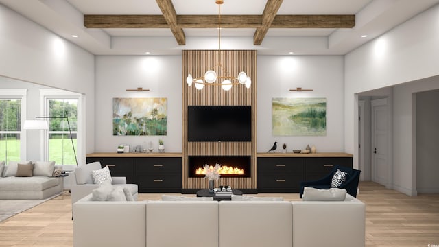 living room with beamed ceiling, light hardwood / wood-style floors, a chandelier, and a large fireplace