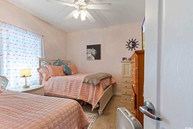 bedroom featuring light carpet and ceiling fan