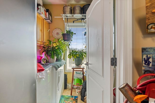 laundry area featuring independent washer and dryer and light tile patterned flooring