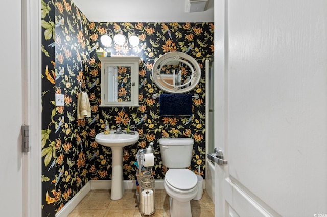 bathroom featuring tile patterned flooring and toilet