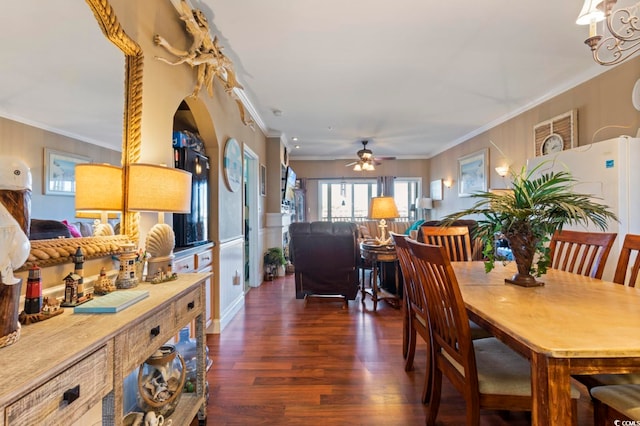 dining area with ornamental molding, ceiling fan, and dark hardwood / wood-style flooring