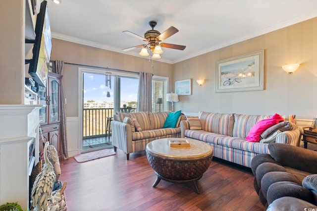 living room with ceiling fan, crown molding, a fireplace, and dark hardwood / wood-style flooring