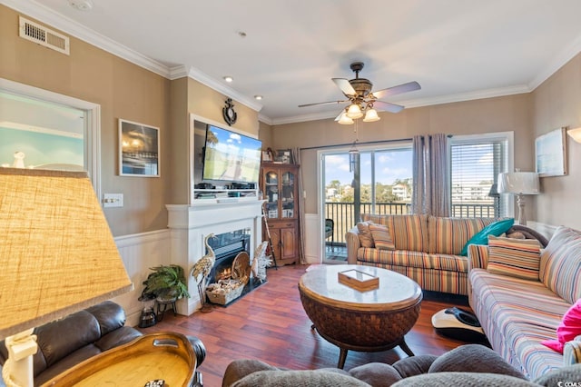 living room featuring ornamental molding, ceiling fan, and hardwood / wood-style floors