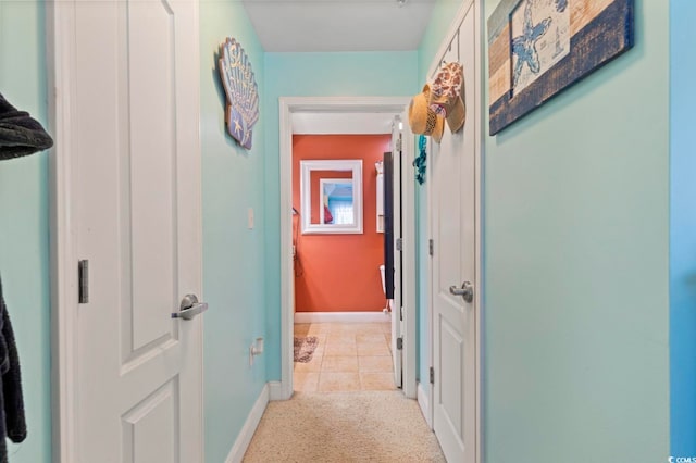 hall featuring light tile patterned floors