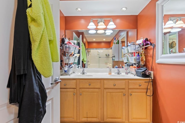 bathroom with walk in shower and vanity