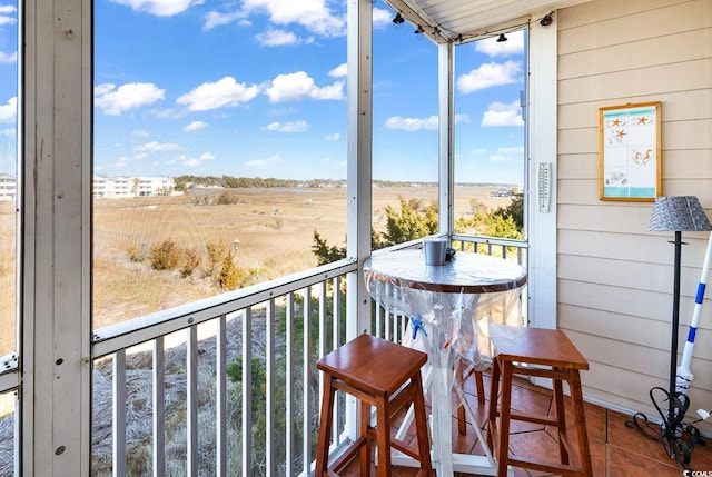 sunroom / solarium featuring a rural view