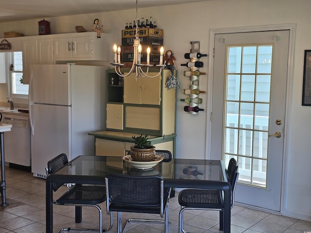 tiled dining space with an inviting chandelier