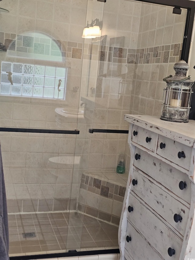 bathroom with a shower with shower door