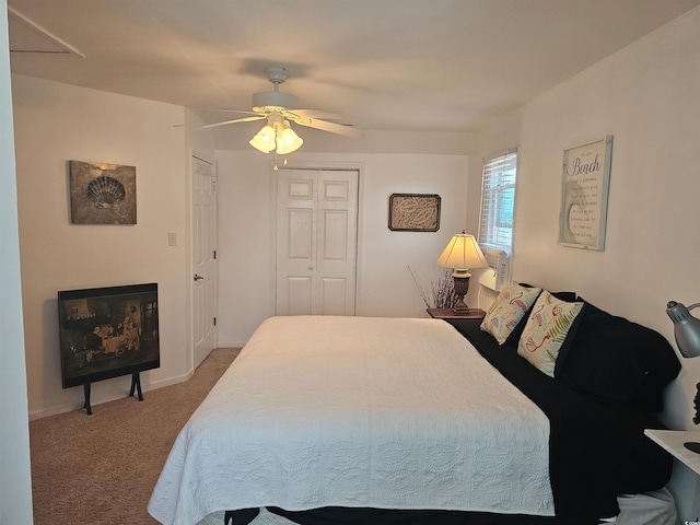 carpeted bedroom featuring a closet and ceiling fan