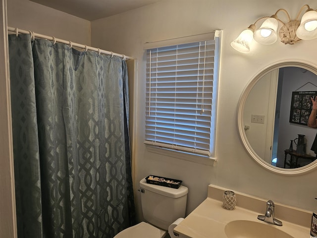 bathroom featuring vanity, toilet, and a shower with shower curtain