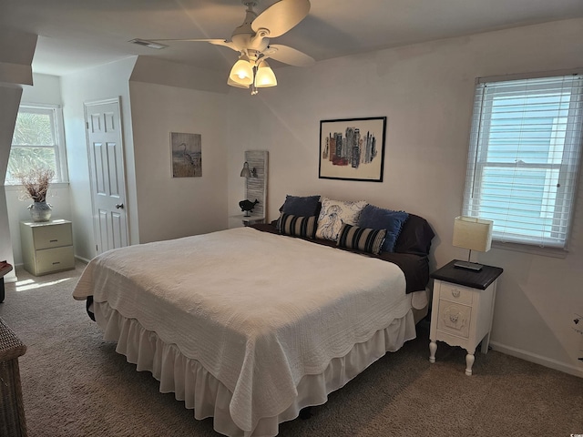 bedroom with dark carpet, a closet, and ceiling fan