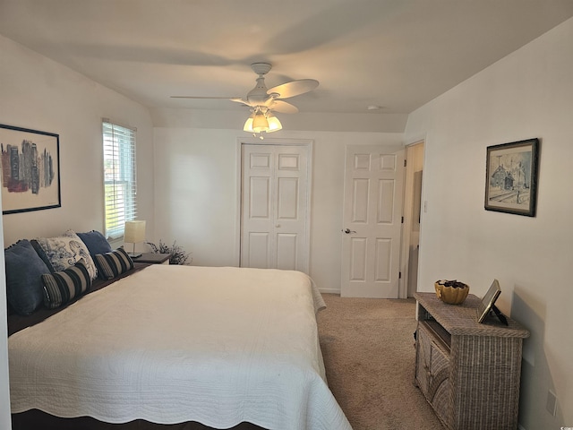 carpeted bedroom with ceiling fan and a closet