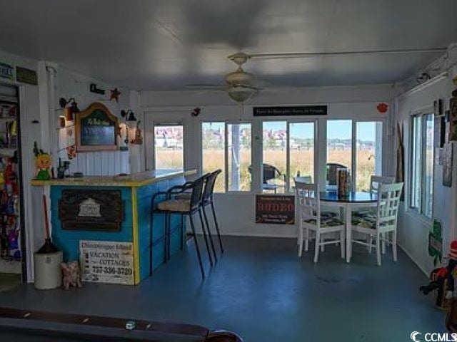 kitchen with ceiling fan, concrete flooring, and a wealth of natural light