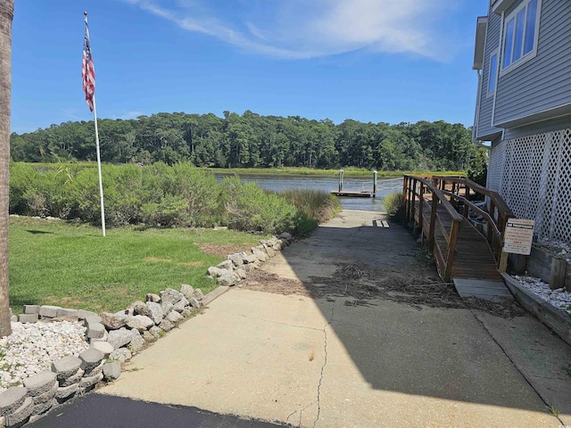 exterior space with a water view and a boat dock