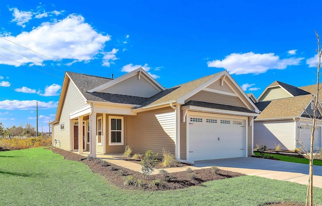 view of front of house with a front yard and a garage