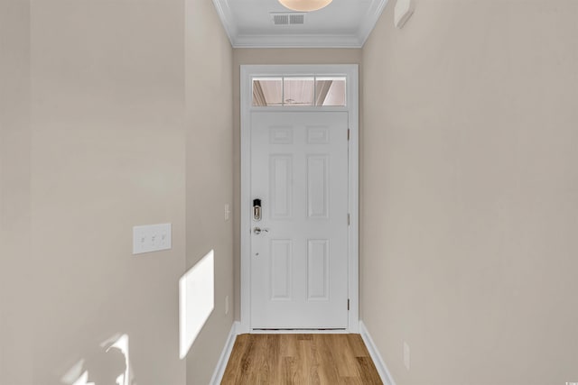 doorway featuring light wood-type flooring and ornamental molding