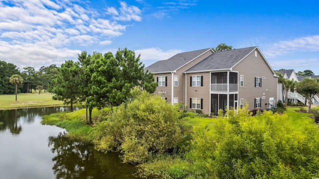 back of house with a water view and a sunroom