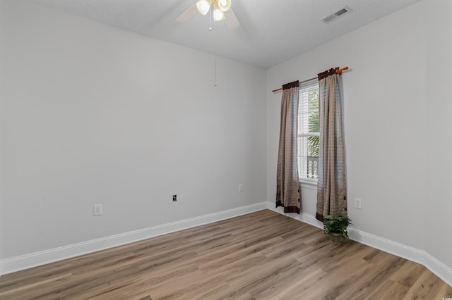 empty room with ceiling fan and light wood-type flooring