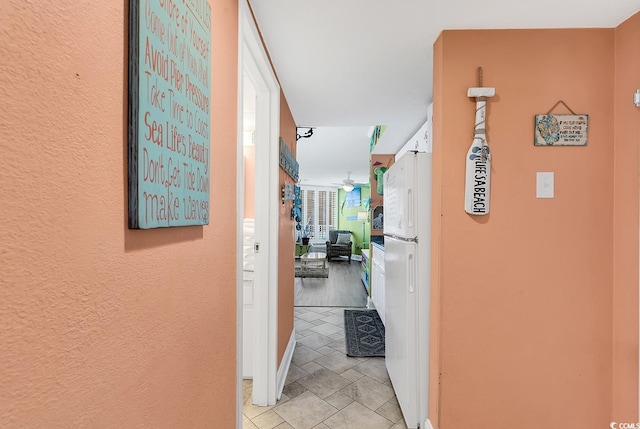 hall with light tile patterned flooring