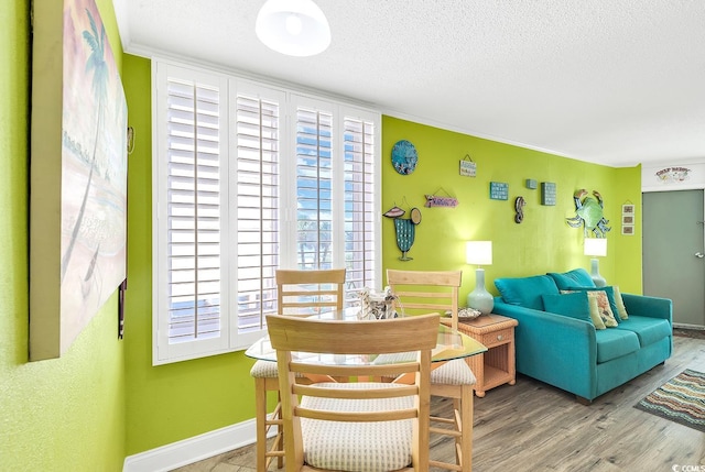 sitting room featuring ornamental molding, hardwood / wood-style floors, and a textured ceiling