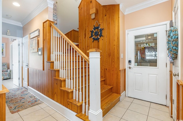 tiled foyer featuring crown molding