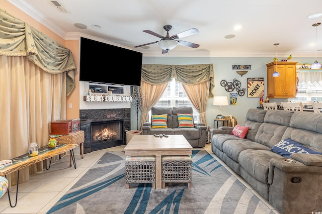 living room with light tile patterned flooring, crown molding, and ceiling fan