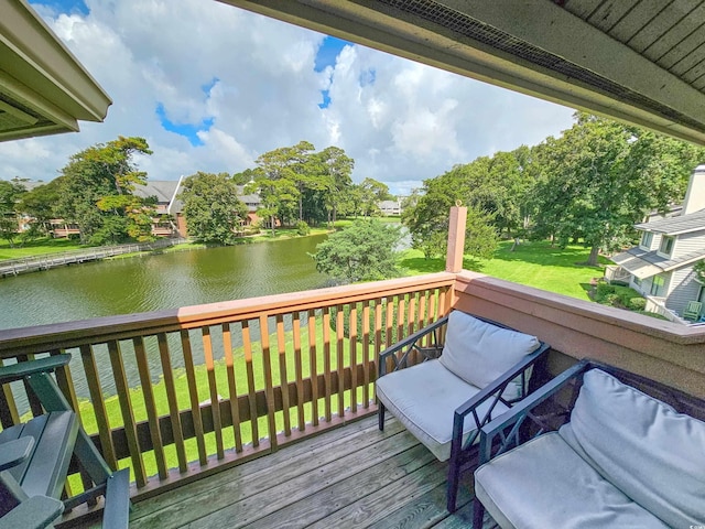 deck with a lawn and a water view