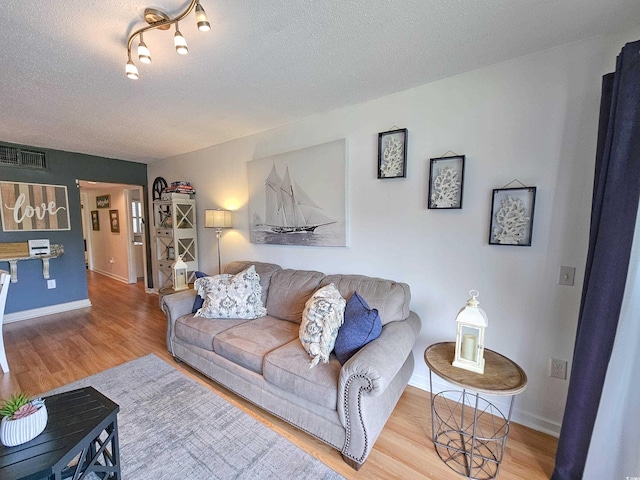 living room featuring a textured ceiling and hardwood / wood-style floors