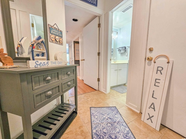 hall featuring light tile patterned floors