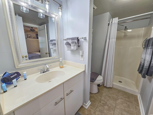 bathroom with vanity, tile patterned flooring, ceiling fan, toilet, and a shower with curtain