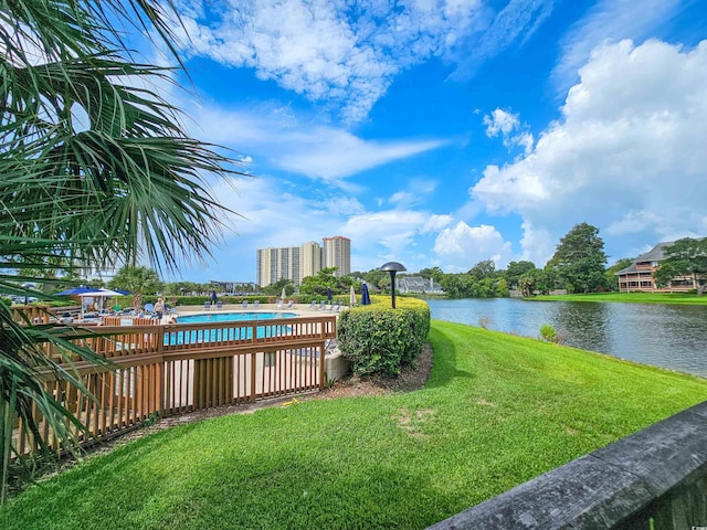 view of yard with a water view and a community pool