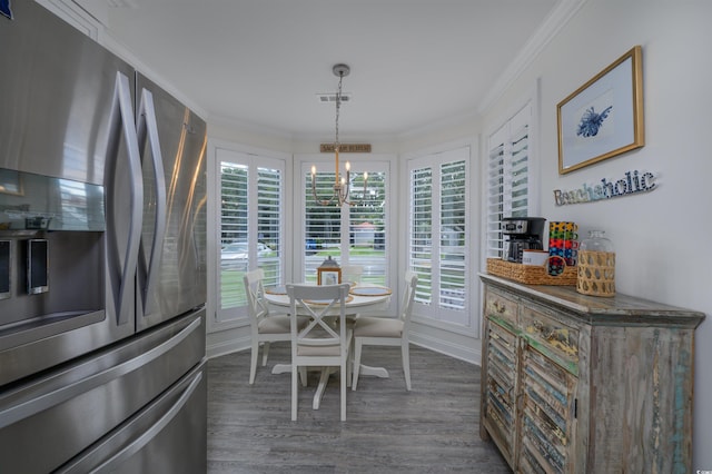 dining area featuring a notable chandelier, dark wood-type flooring, and ornamental molding