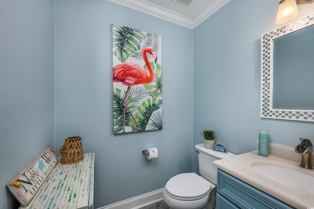 bathroom with crown molding, vanity, and toilet