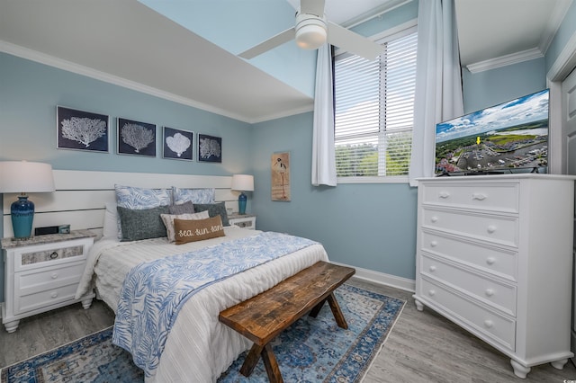 bedroom with hardwood / wood-style flooring, ceiling fan, and ornamental molding