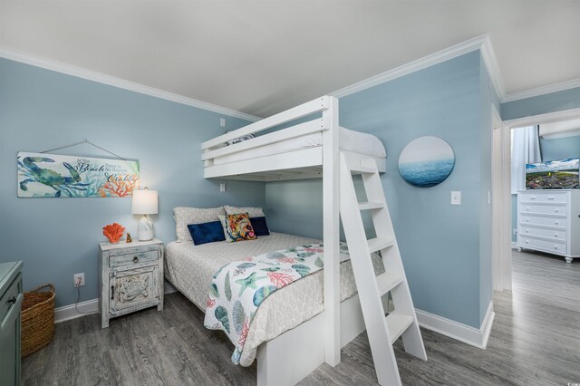 bedroom with crown molding and dark hardwood / wood-style flooring